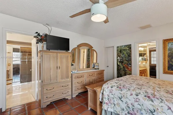 a living room with stainless steel appliances lots of furniture and kitchen view