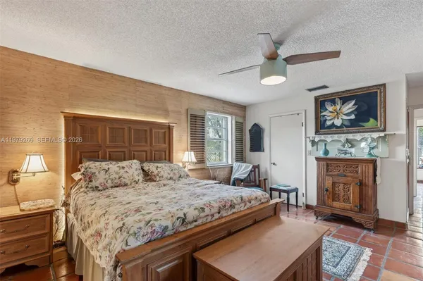 a living room with stainless steel appliances furniture a rug and a view of kitchen