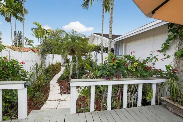a view of a table and chairs under an umbrella
