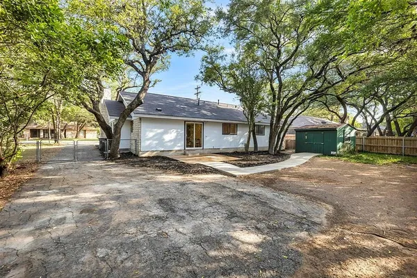 a house that has a tree in front of it