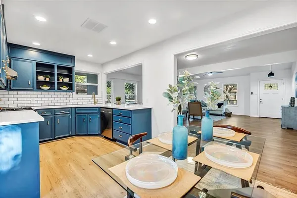 a kitchen with a sink stove and chairs