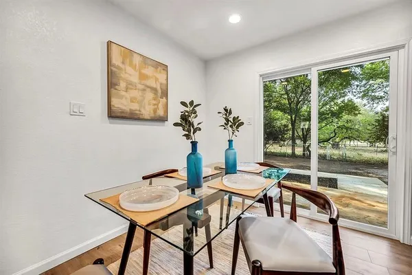 a dining room with furniture and wooden floor