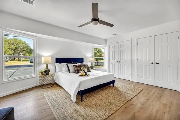 a spacious bedroom with a bed and large window