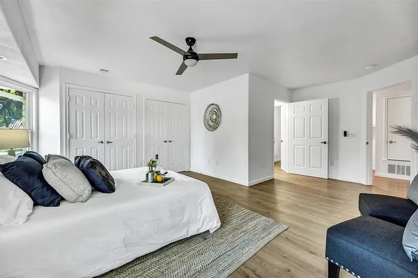 a bedroom with a bed and wooden floor