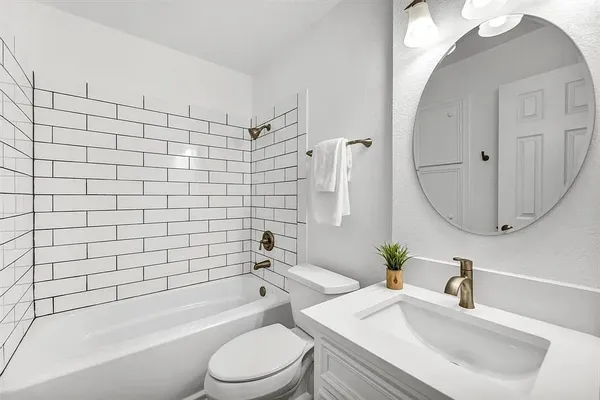 a bathroom with a sink a toilet and bathtub