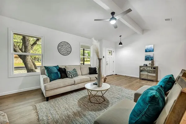a living room with furniture a clock and a window