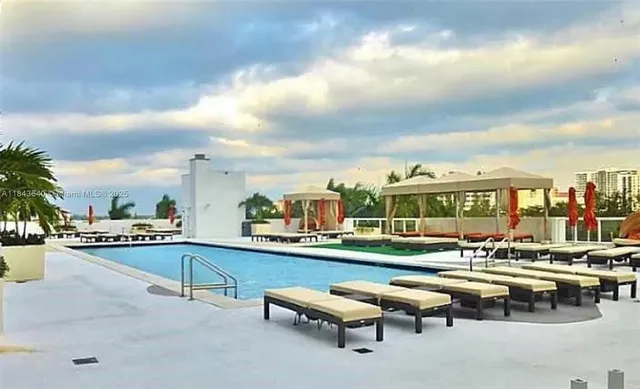 a view of a swimming pool with outdoor seating