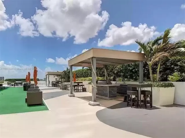 a view of a patio with swimming pool and furniture