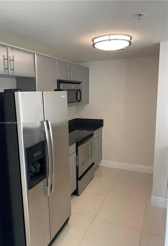 a utility room with refrigerator and washer