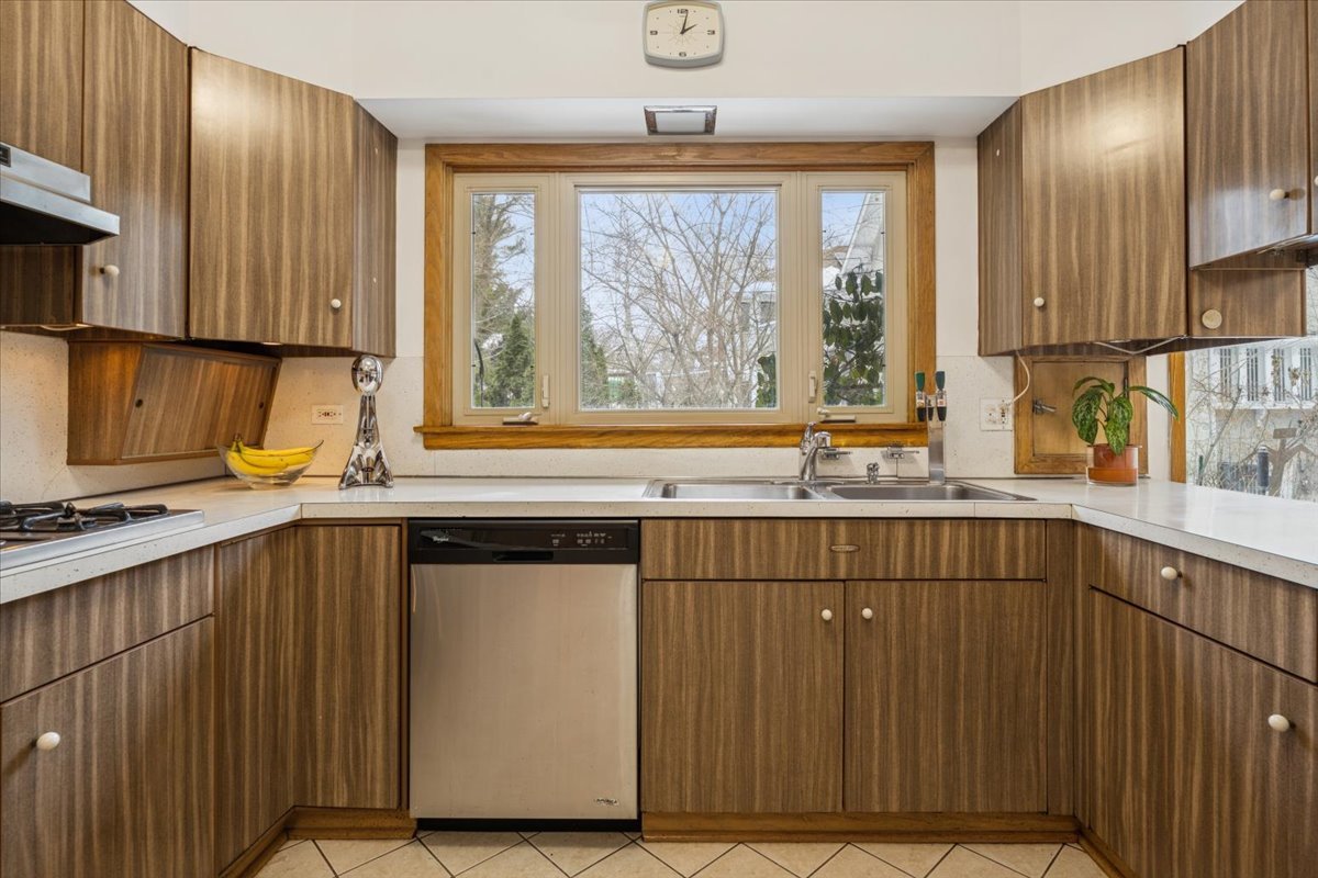 744 Sheridan Road Evanston, IL 60202 - Photo 15 of 44 a kitchen with a sink window and cabinets