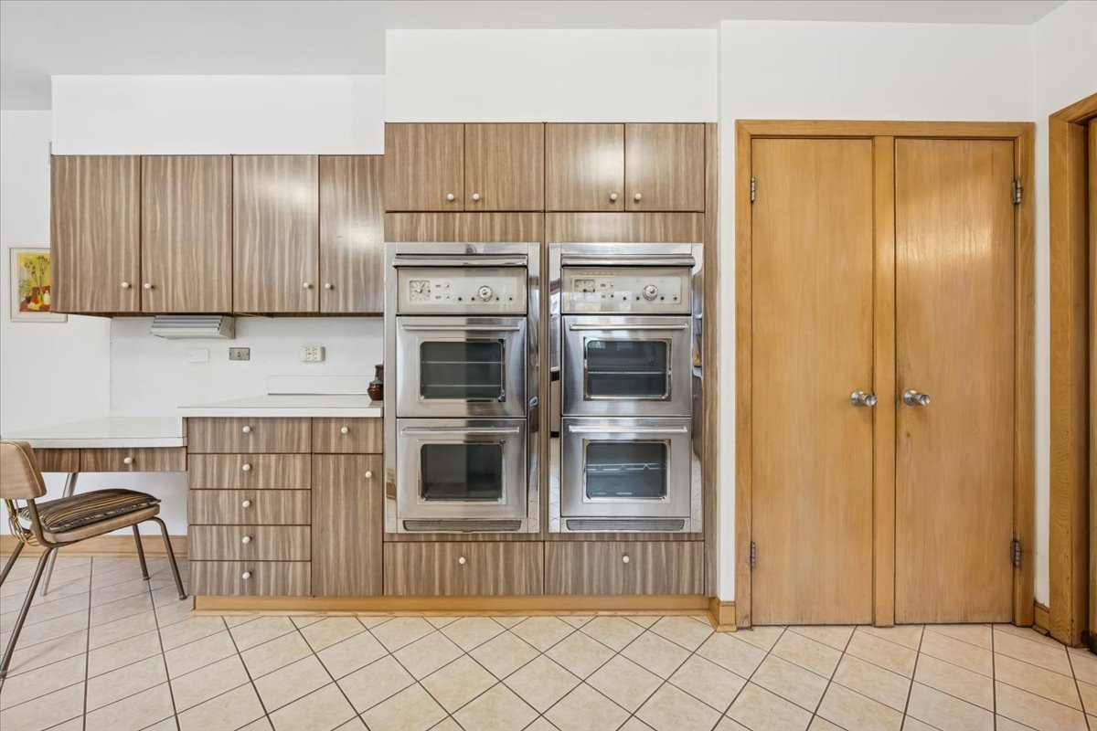 744 Sheridan Road Evanston, IL 60202 - Photo 16 of 44 a kitchen with granite countertop a refrigerator and a stove top oven