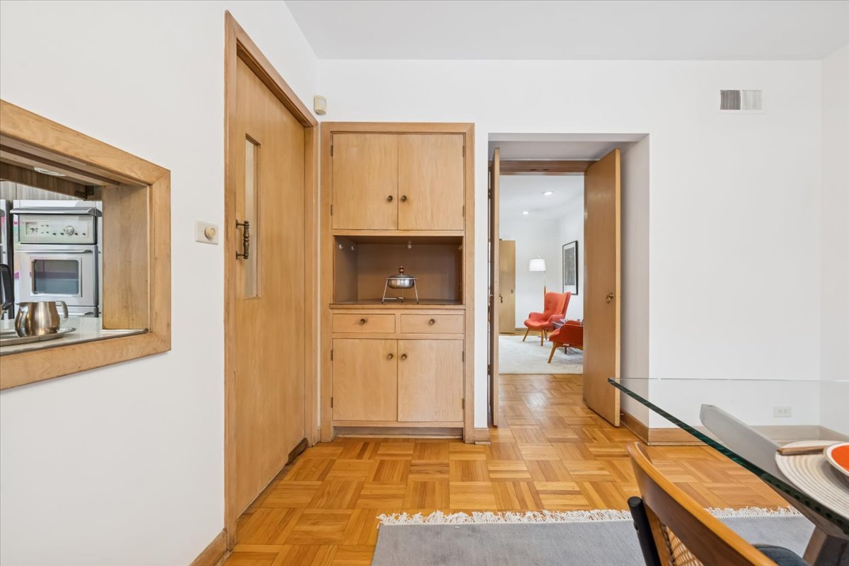 744 Sheridan Road Evanston, IL 60202 - Photo 19 of 44 a view of a hallway with wooden floor and a living room
