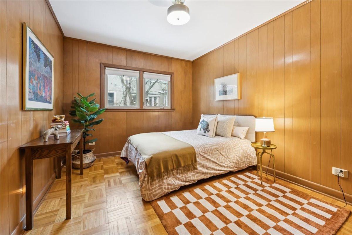 744 Sheridan Road Evanston, IL 60202 - Photo 31 of 44 a bedroom with a bed and wooden floor