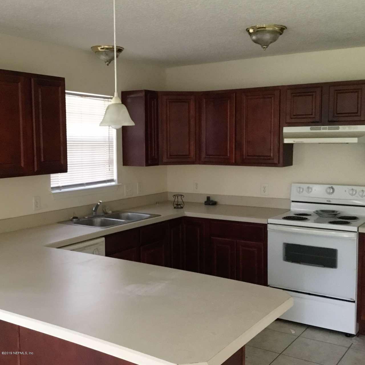 2170 Brooklyn Road Jacksonville, FL 32209 - Photo 9 of 10 a kitchen with granite countertop a sink stainless steel appliances and cabinets