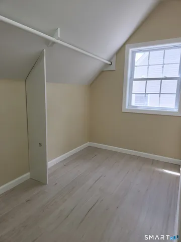an empty room with windows and closet
