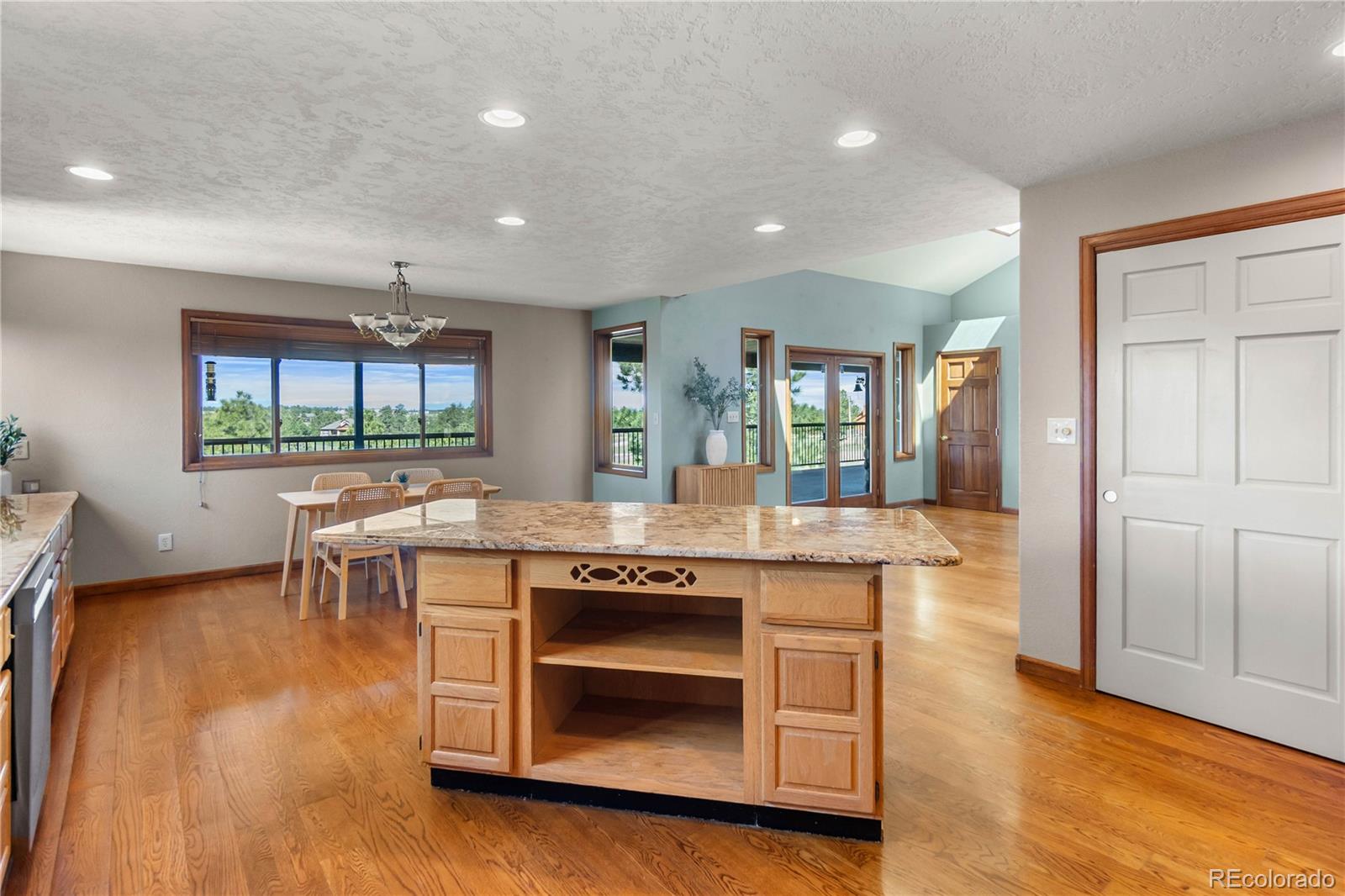 74 Rocky Cliff Road Elizabeth, CO 80107 - Photo 16 of 50 a kitchen with a stove and a wooden floor