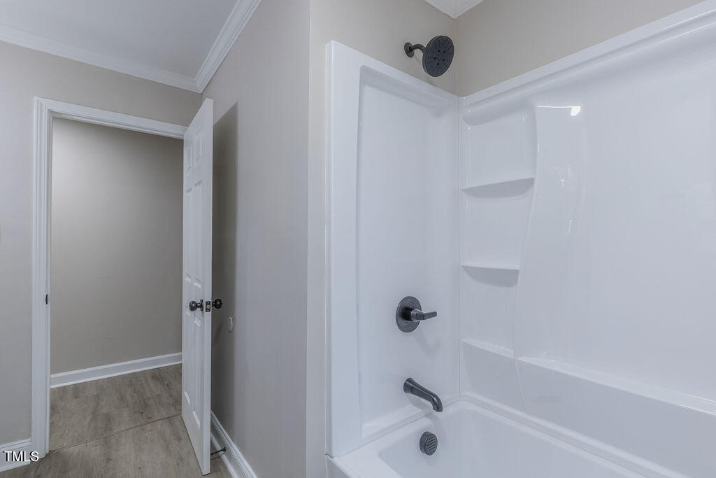 4814 Fayetteville Road Durham, NC 27713 - Photo 17 of 32 a bathroom with a bathtub and shower