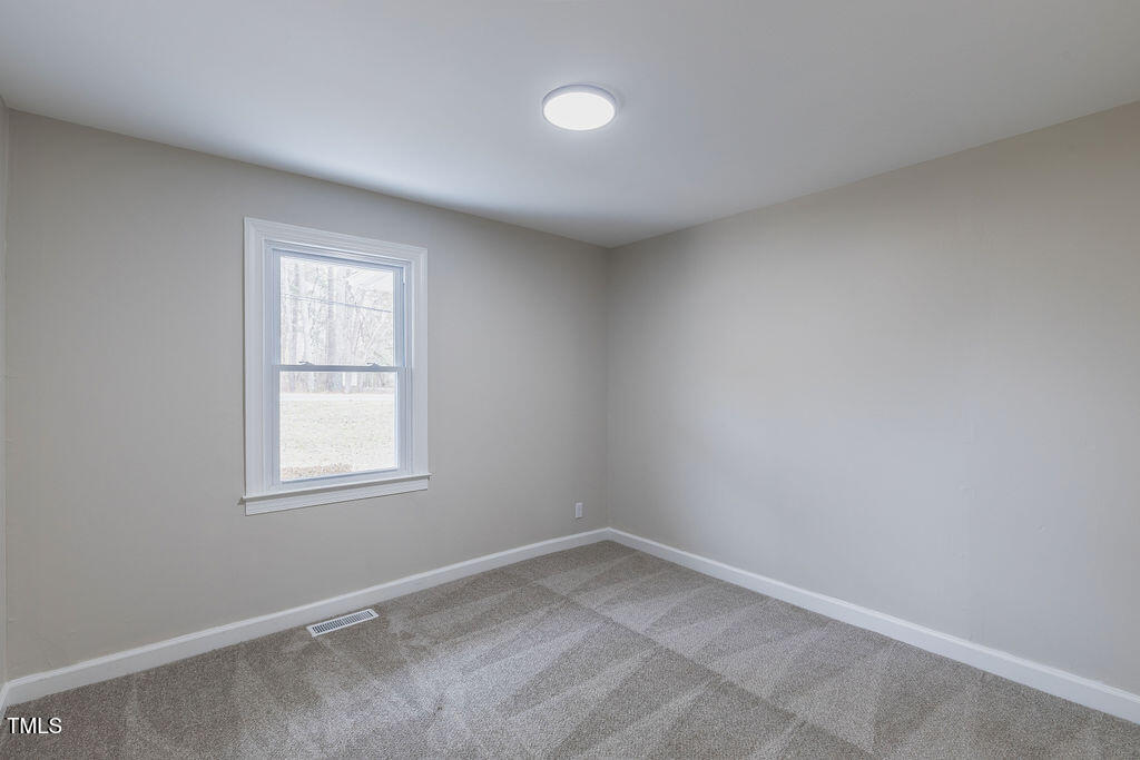 4814 Fayetteville Road Durham, NC 27713 - Photo 18 of 32 an empty room with a window