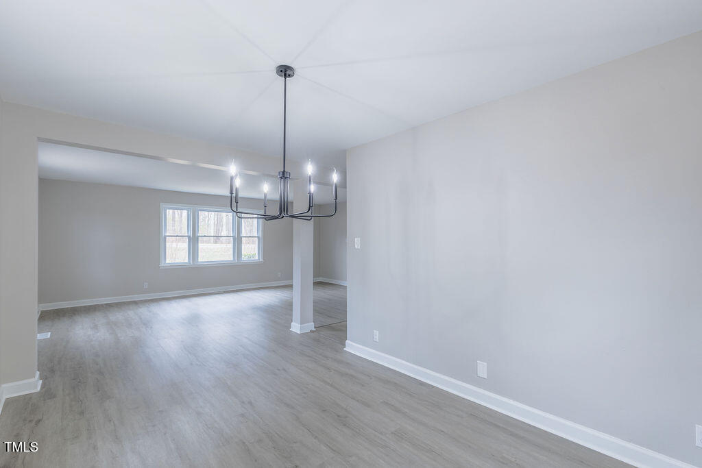 4814 Fayetteville Road Durham, NC 27713 - Photo 6 of 32 a view of a room with wooden floor chandelier and window
