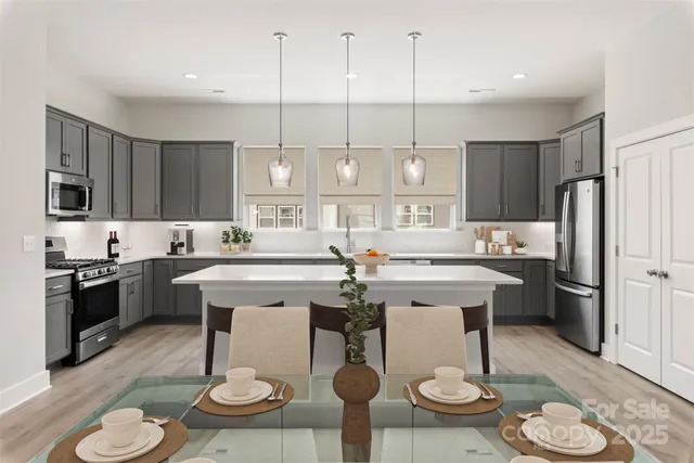 a kitchen with stainless steel appliances kitchen island granite countertop a sink and cabinets
