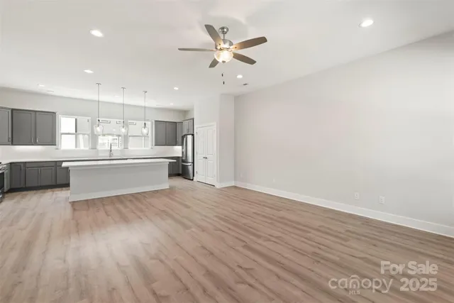 a view of kitchen with wooden floor and windows