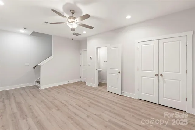 an empty room with fan and a ceiling fan