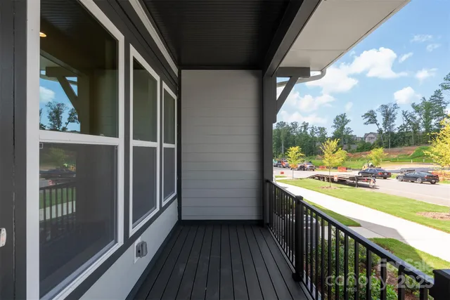 a view of a balcony with wooden floor