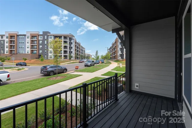 a balcony with wooden floor and outdoor seating