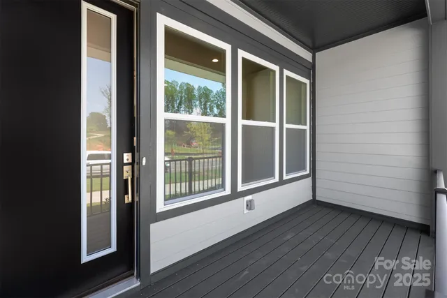 a view of a room with wooden floor and windows