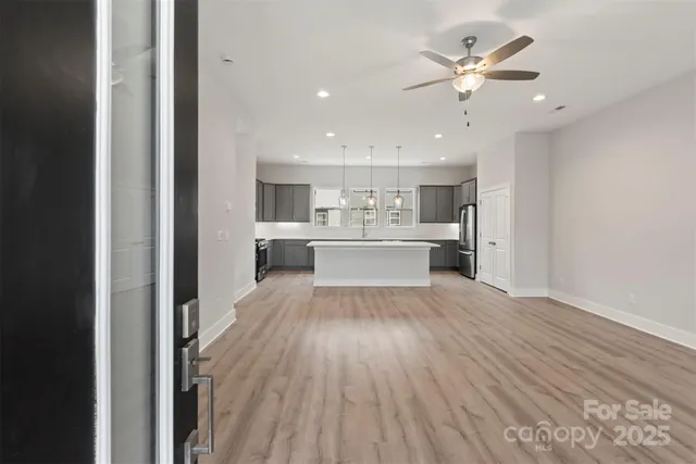 a view of a kitchen with a sink and a refrigerator