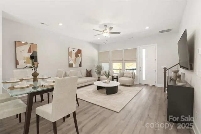 a living room with furniture a window and a flat screen tv