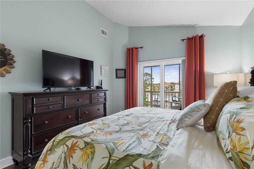 102 Rivers Edge Lane, Unit 102 Palm Coast, FL 32137 - Photo 16 of 67 a bedroom with a bed and a flat screen tv