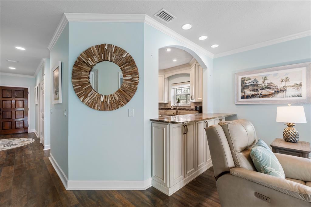 102 Rivers Edge Lane, Unit 102 Palm Coast, FL 32137 - Photo 21 of 67 a living room with furniture a mirror and wooden floor