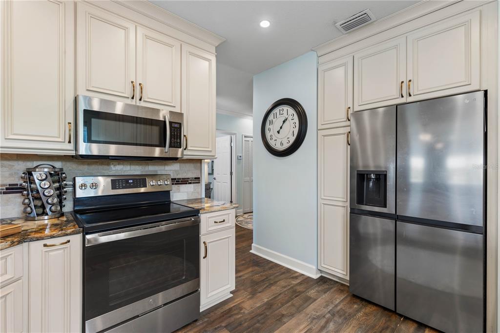 102 Rivers Edge Lane, Unit 102 Palm Coast, FL 32137 - Photo 23 of 67 a kitchen with a refrigerator stove and microwave