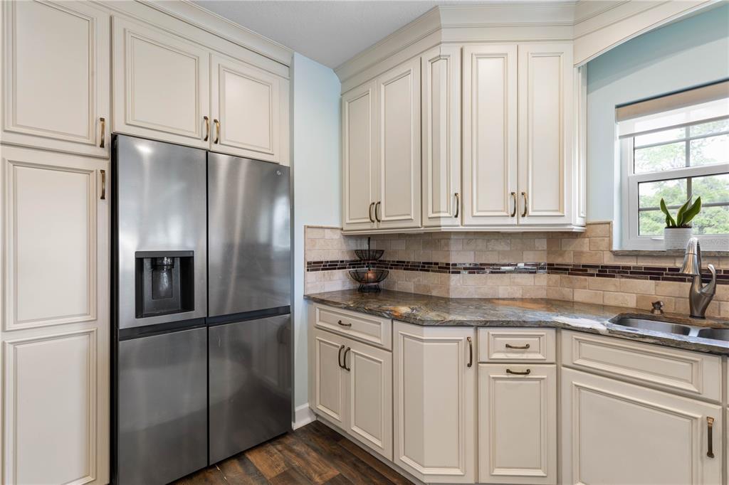 102 Rivers Edge Lane, Unit 102 Palm Coast, FL 32137 - Photo 24 of 67 a kitchen with stainless steel appliances granite countertop a refrigerator a sink and white cabinets