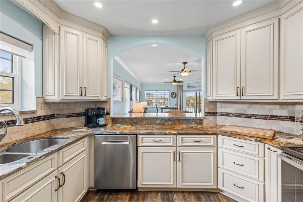 102 Rivers Edge Lane, Unit 102 Palm Coast, FL 32137 - Photo 26 of 67 a kitchen with granite countertop white cabinets and white appliances