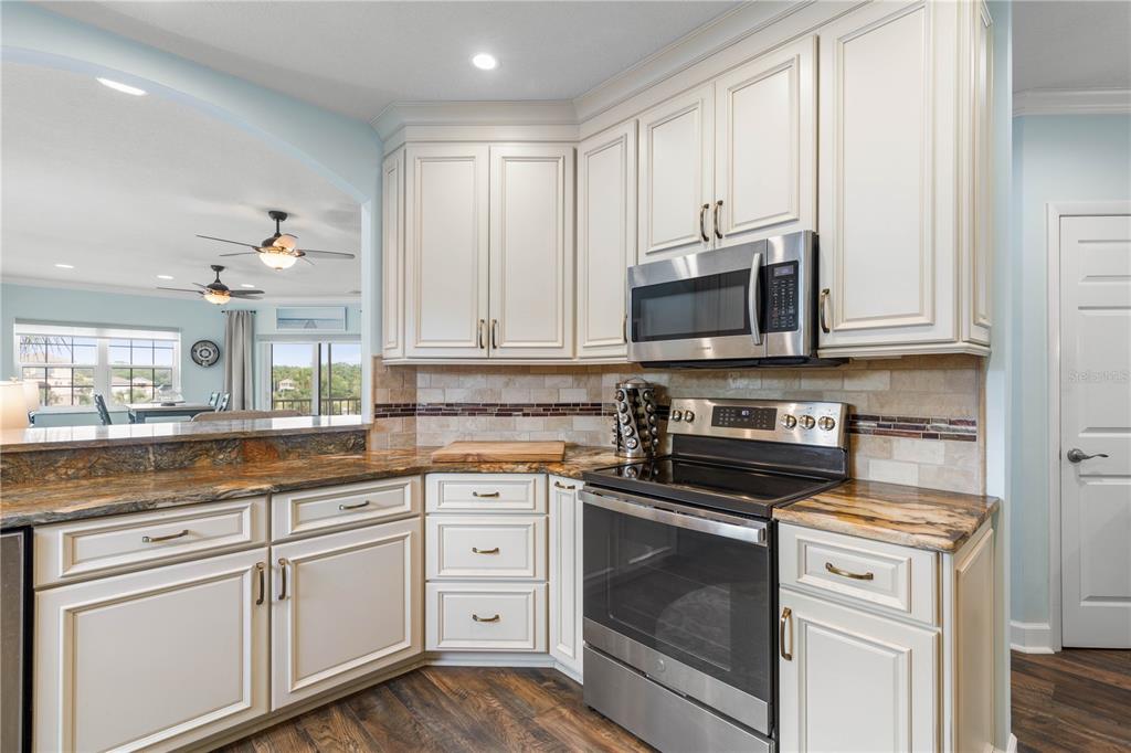 102 Rivers Edge Lane, Unit 102 Palm Coast, FL 32137 - Photo 27 of 67 a kitchen with granite countertop white cabinets and stainless steel appliances