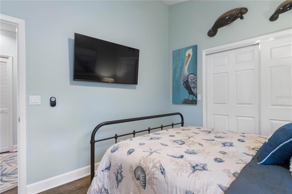 102 Rivers Edge Lane, Unit 102 Palm Coast, FL 32137 - Photo 33 of 67 a bedroom with a bed and a flat screen tv