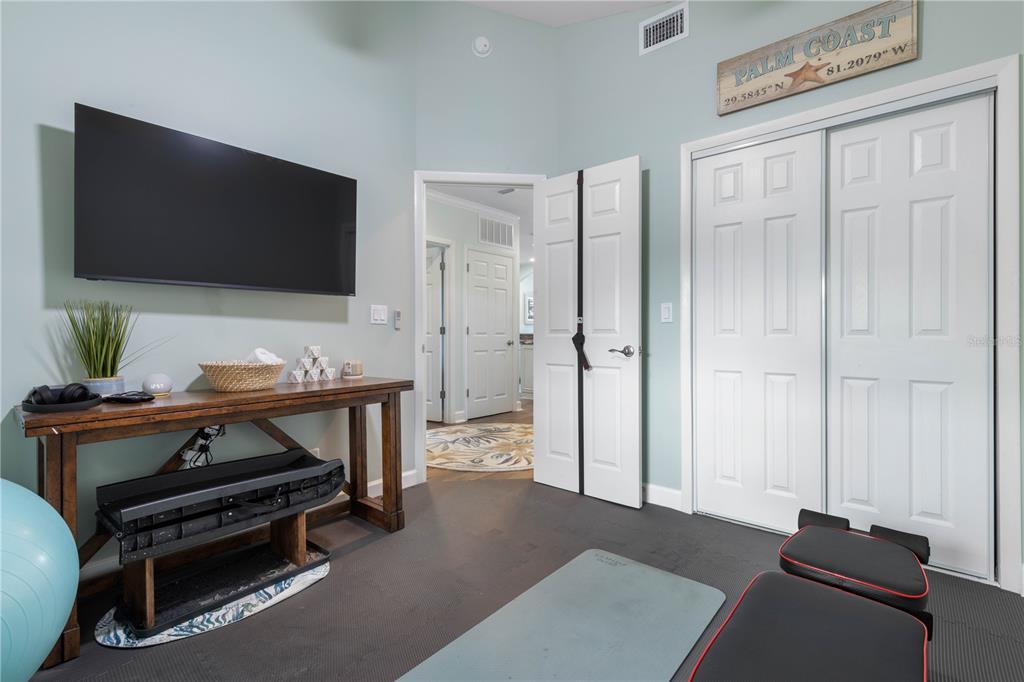 102 Rivers Edge Lane, Unit 102 Palm Coast, FL 32137 - Photo 35 of 67 a living room with furniture and a flat screen tv