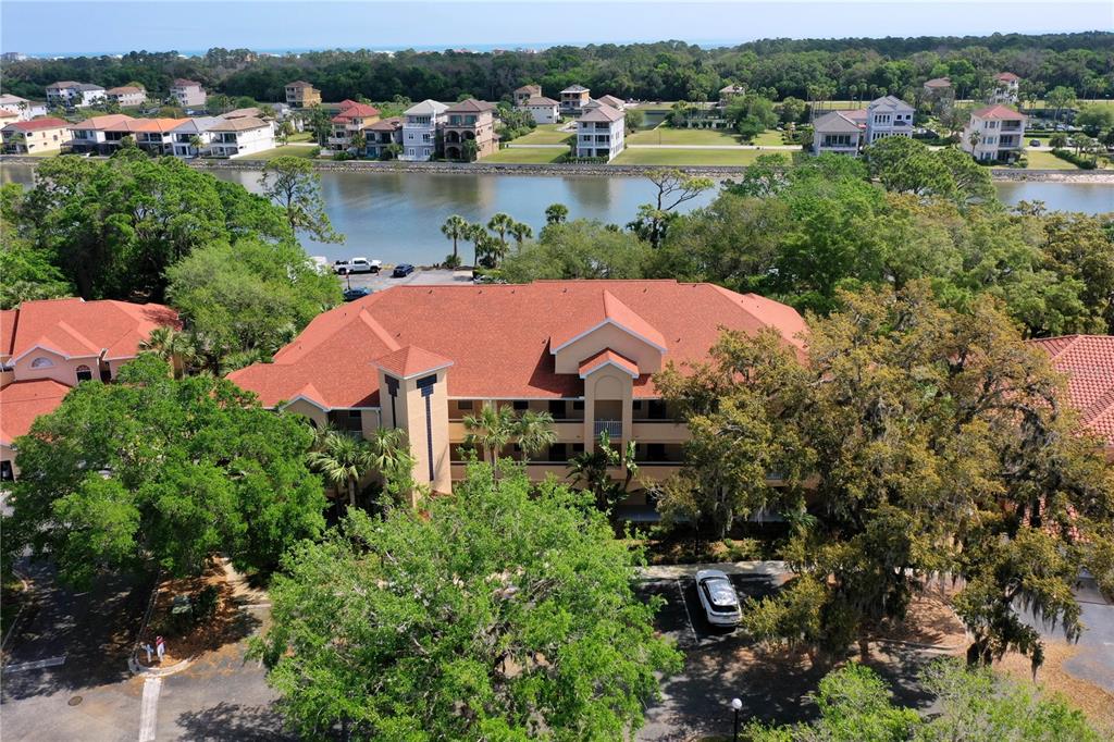 102 Rivers Edge Lane, Unit 102 Palm Coast, FL 32137 - Photo 40 of 67 an aerial view of a house with garden space and lake view