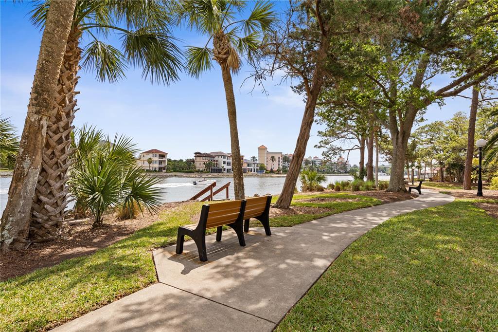 102 Rivers Edge Lane, Unit 102 Palm Coast, FL 32137 - Photo 58 of 67 a view of a swimming pool with a table and chairs