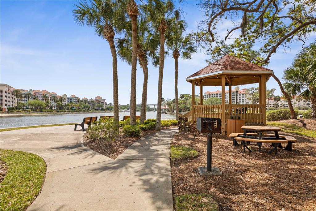 102 Rivers Edge Lane, Unit 102 Palm Coast, FL 32137 - Photo 59 of 67 a view of a lake with a table and chairs under an umbrella