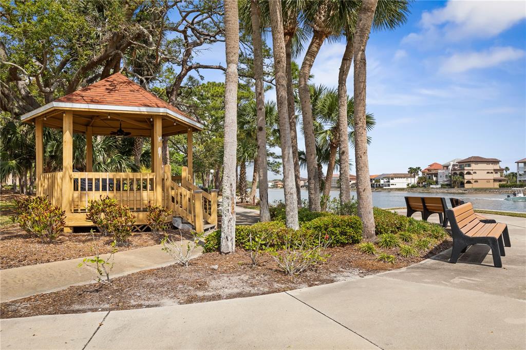 102 Rivers Edge Lane, Unit 102 Palm Coast, FL 32137 - Photo 60 of 67 a front view of a house with a yard and potted plants