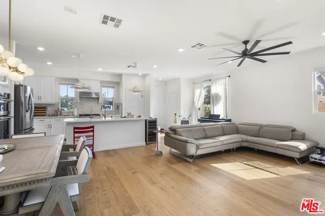 a living room with furniture and kitchen view