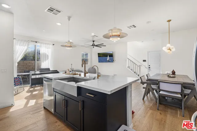 a kitchen with a sink a stove and chairs