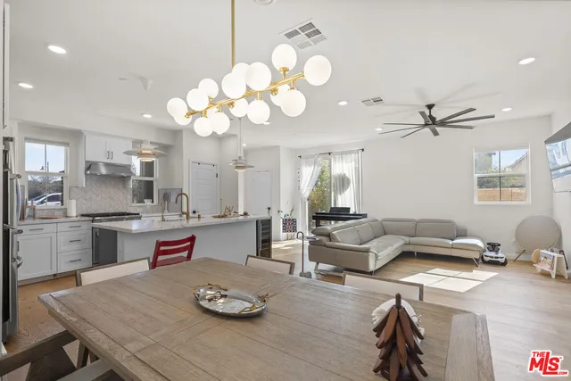 a living room with kitchen island furniture and a chandelier