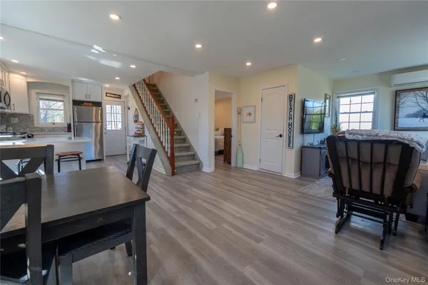 a view of a dining room with furniture and wooden floor