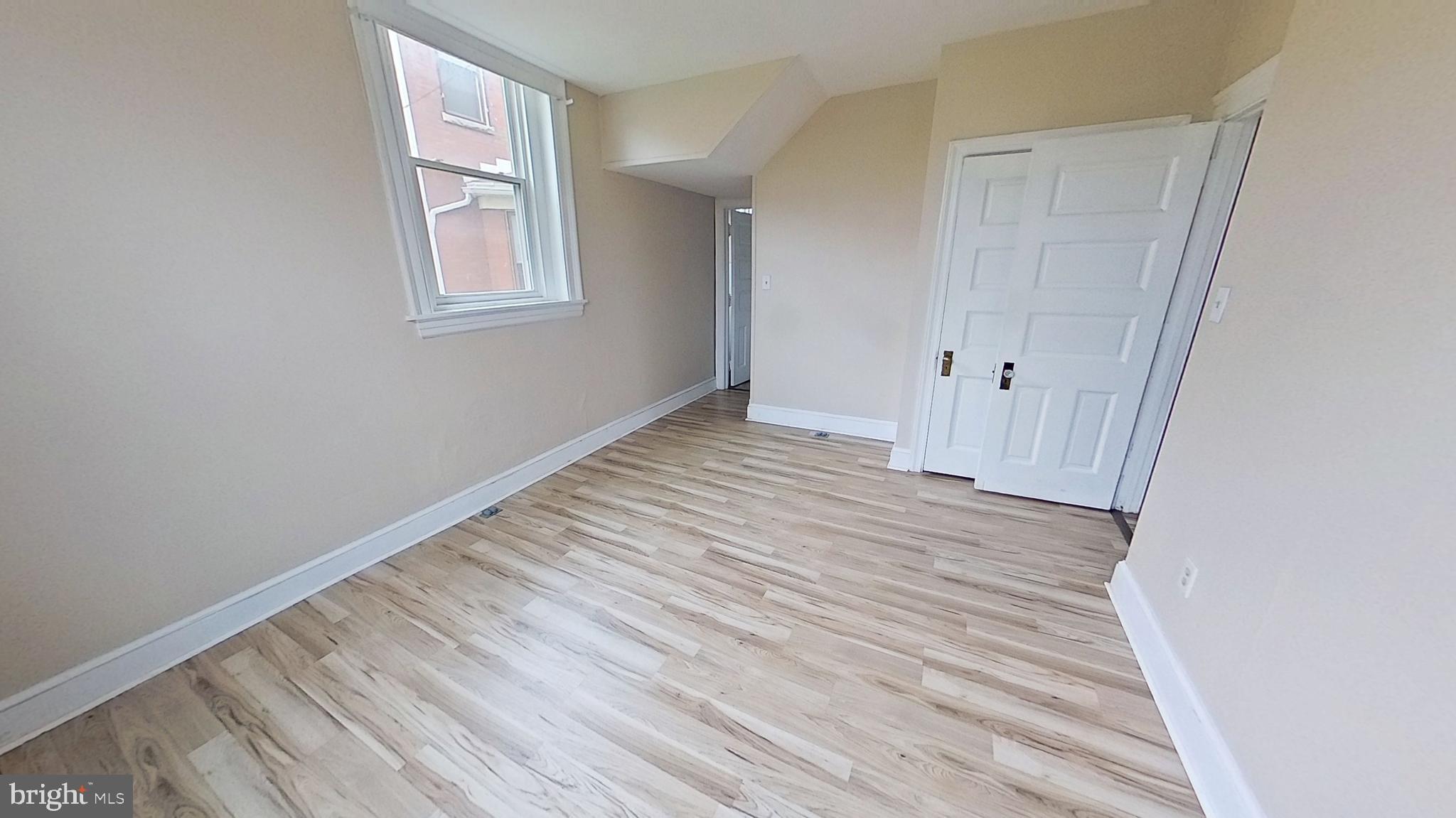 200 Carlisle Street, Unit A Hanover, PA 17331 - Photo 13 of 14 a view of a room with wooden floor and entryway