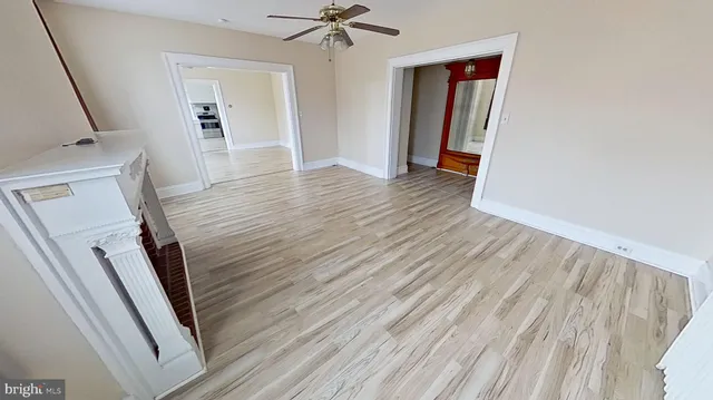 a view of a livingroom with wooden floor and staircase