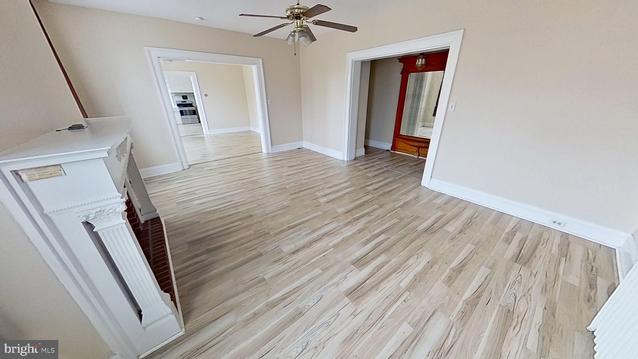 200 Carlisle Street, Unit A Hanover, PA 17331 - Photo 3 of 14 wooden floor in an empty room with a fireplace